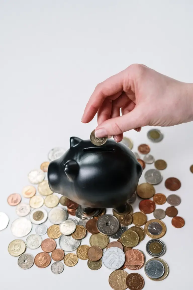 Two jars labelled saving and investing side by side illustrating the difference between saving vs investing for beginners